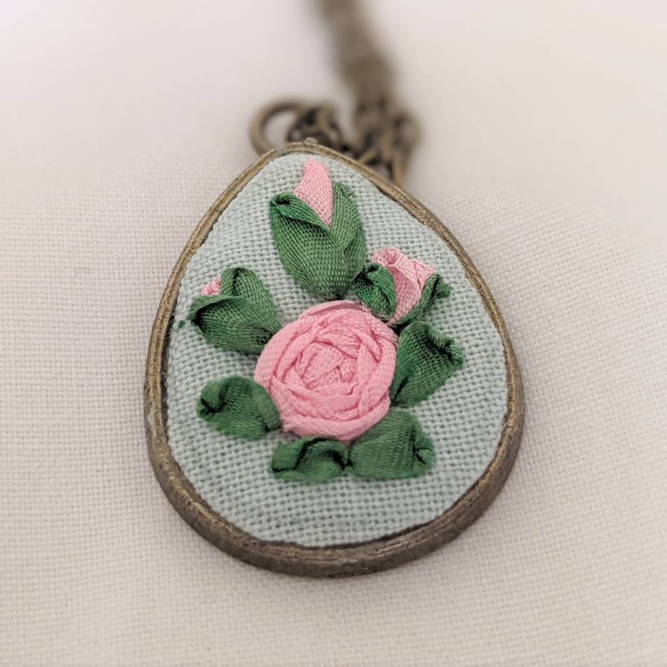 Embroidered roses teardrop pendant