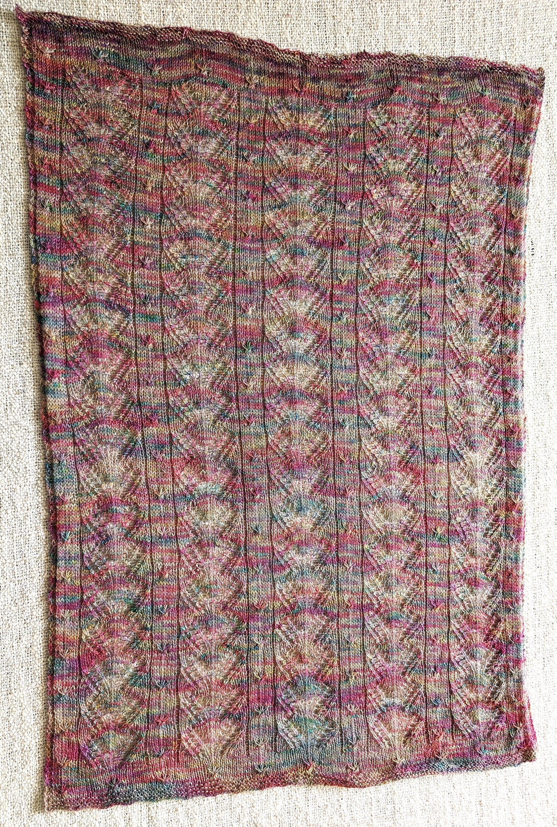 A multicolour lace pattern knitted baby blanket
